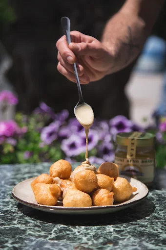 traditional loukoumades with white chocolate  - agora 1955 portaria volos 